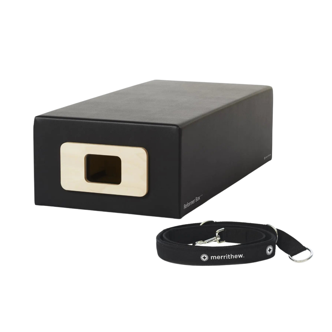 Black yoga block with a strap on a white background