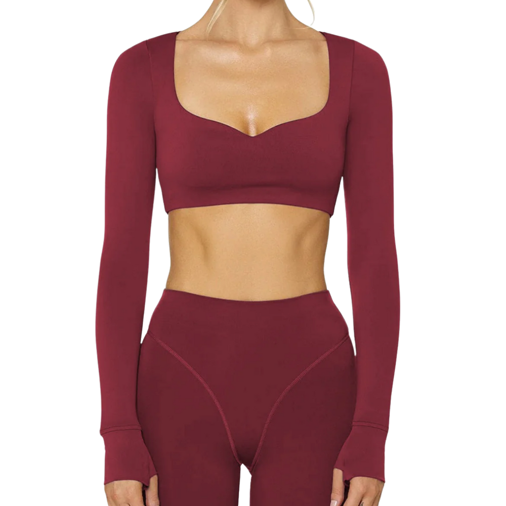 Maroon long-sleeve athletic top and leggings set on a white background