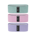 Three resistance bands in green, pink, and purple with visible labels on a white background.