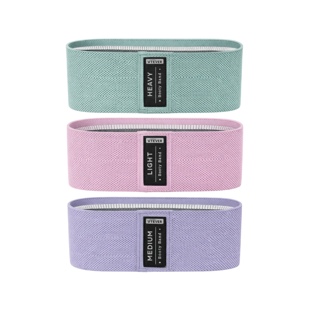 Three resistance bands in green, pink, and purple with visible labels on a white background.